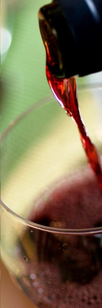 Red wine being poured into a glass.