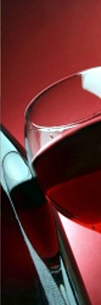 A Bottle of red wine with a half full glass.